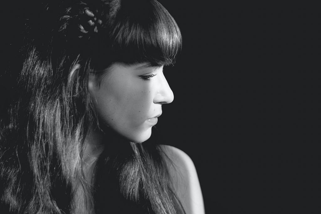 A black and white photo of a woman in profile