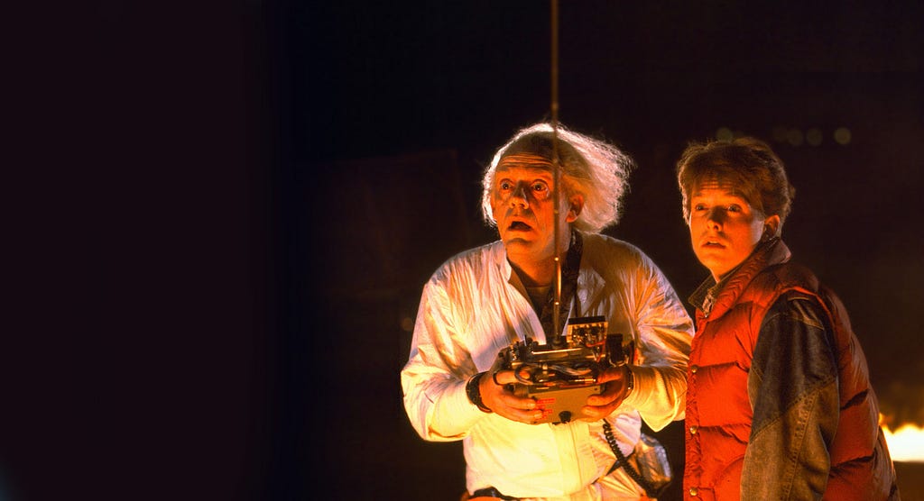 Doc and Marty from Back to the Future. Doc holding a remote control.