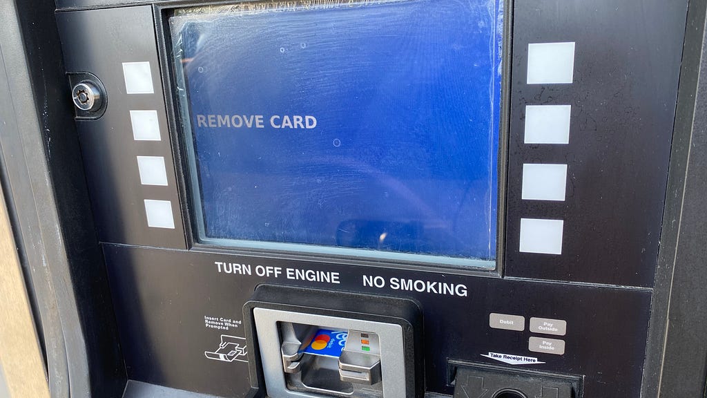 The blue payment screen at a gas pump that says remove card