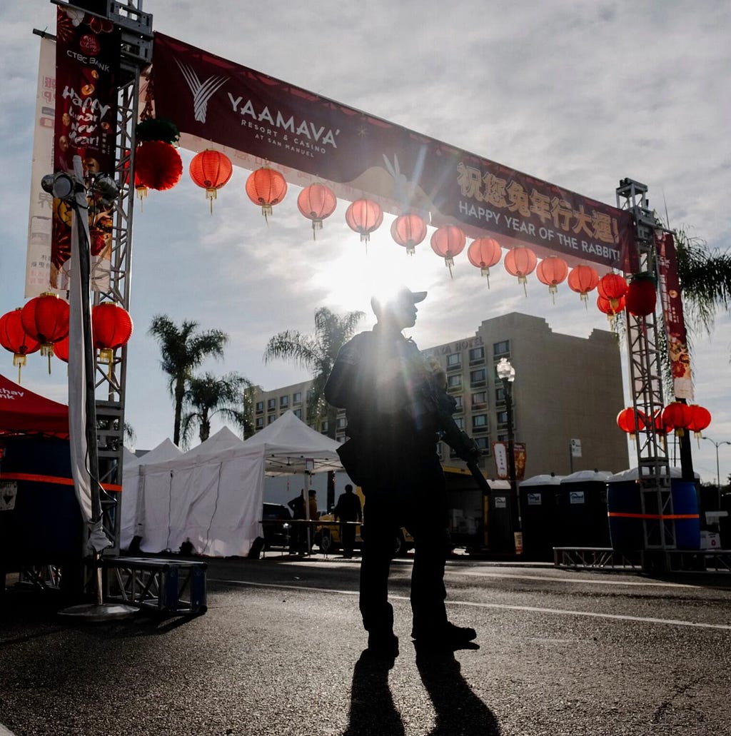 Police officer standing guard during the aftermath of the shooting, following day