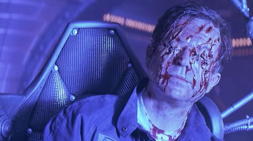 Screenshot of eye-less Dr. William Weir (Sam Neill) from the movie Even Horizon