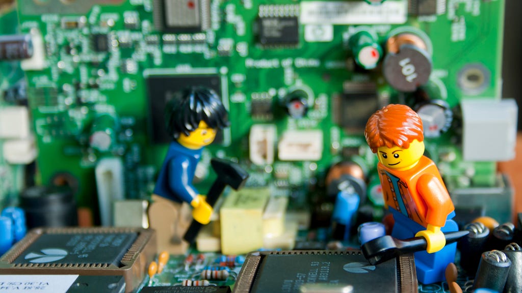 Lego people fixing computers