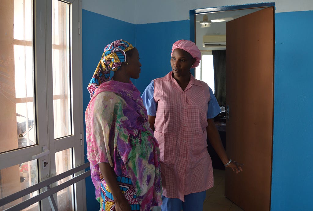 Mama Diancoumba (right) always takes time to reassure her patients and go over their concerns.