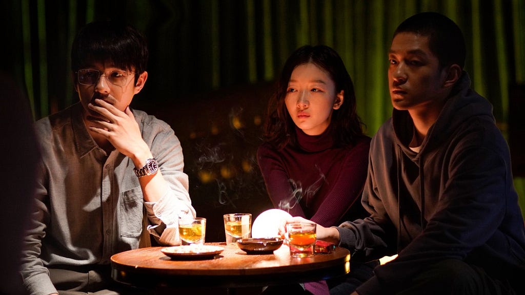 Still of two men and a woman in The Breaking Ice, directed by Anthony Chen.