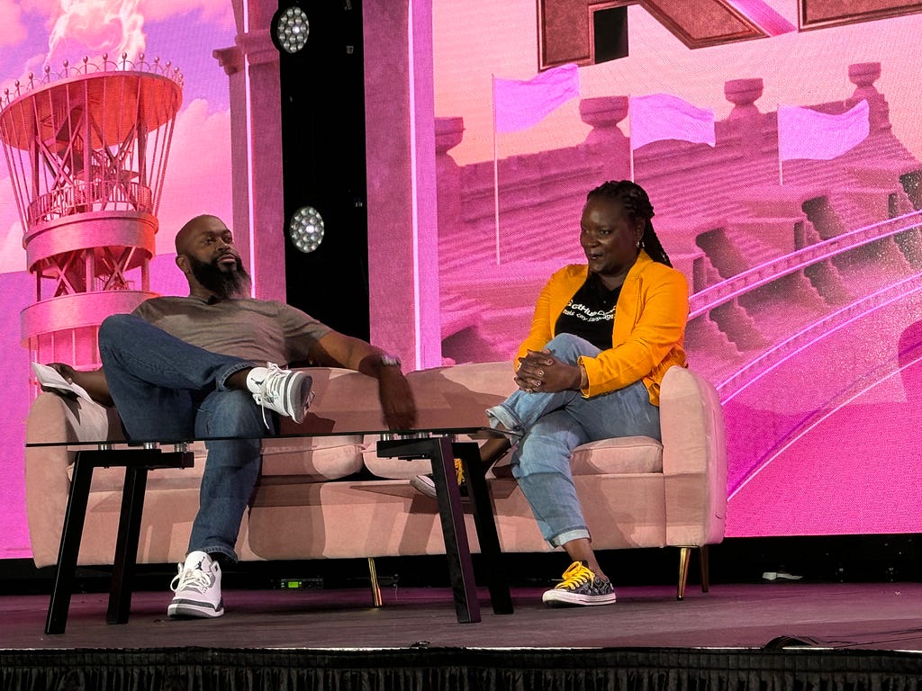 Demetris Cheatham presenting for GitHub and speaking in a fireside discussion on the main event stage.