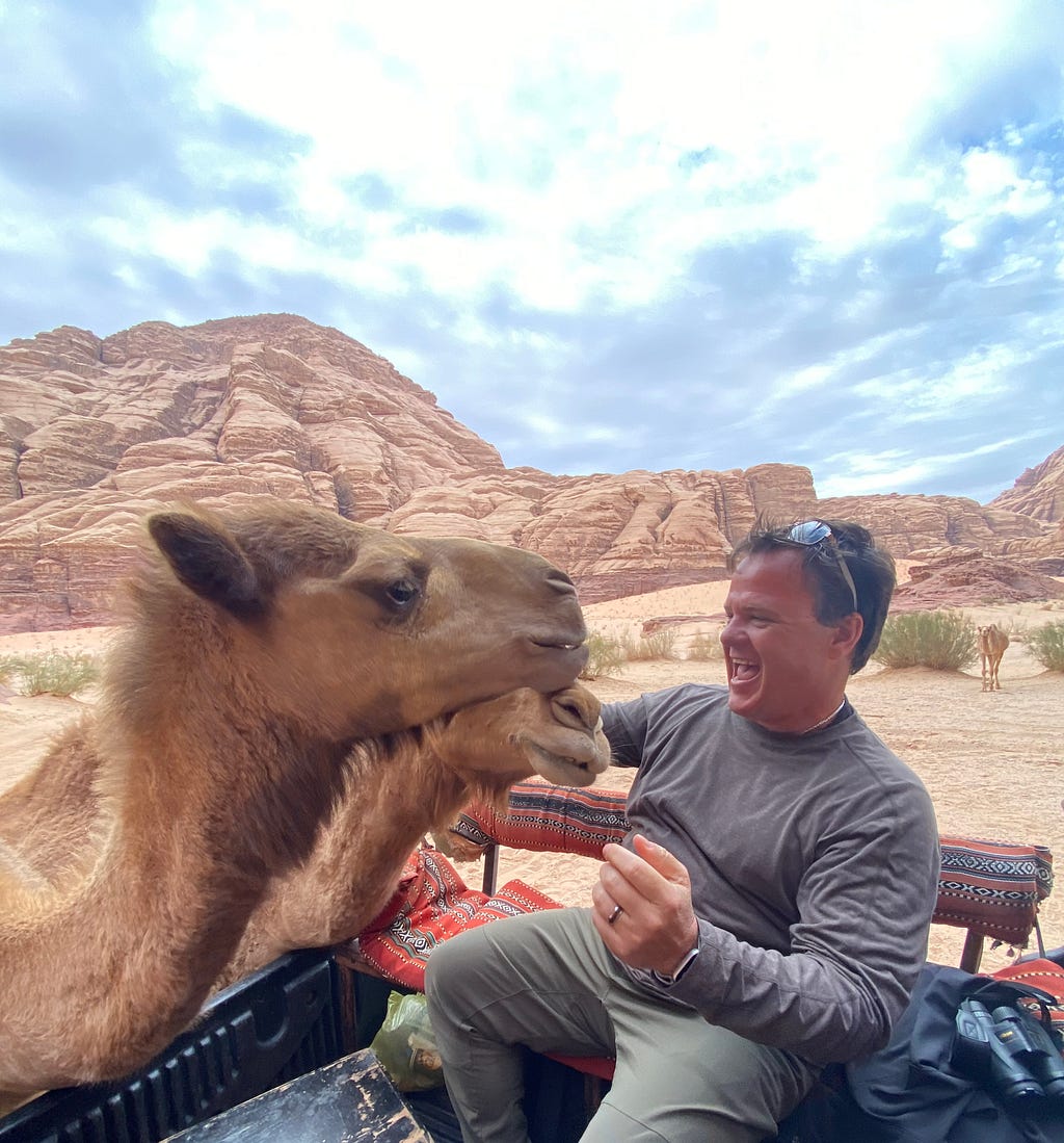 Ronnie feeding 2 camels in Wadi Rum Jordan