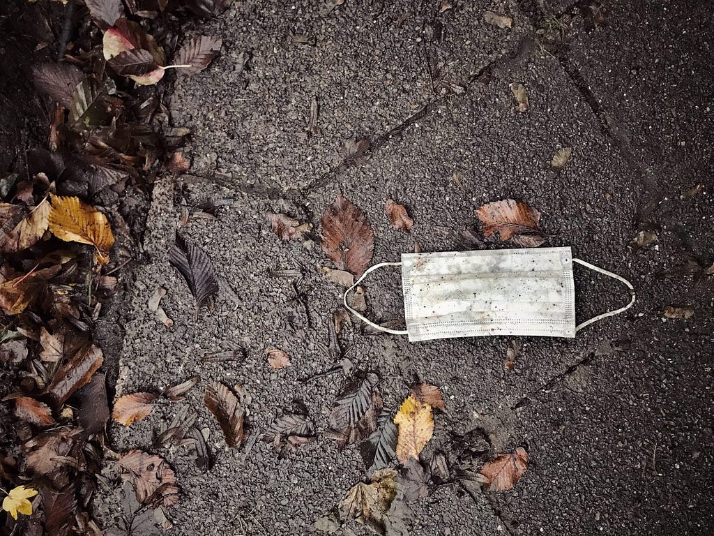 A mask on the sidewalk.