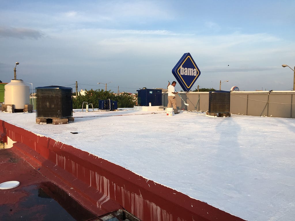 Terracotta roof being painted white in Veracruz, Mexico