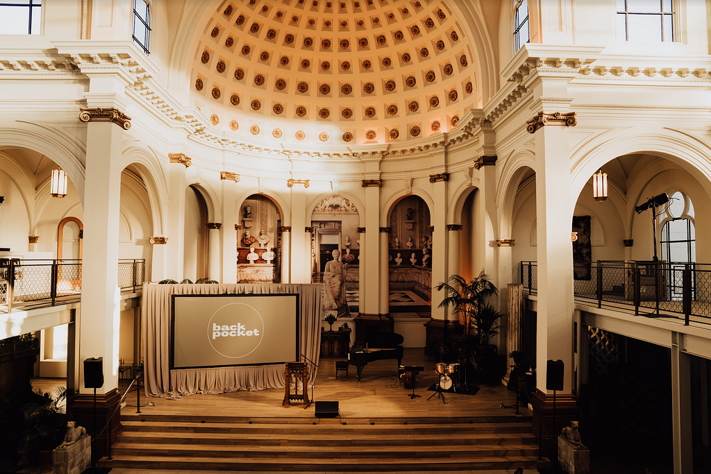 A photo of a stage set up at a church, with Back Pocket Media’s logo appearing on a TV screen.