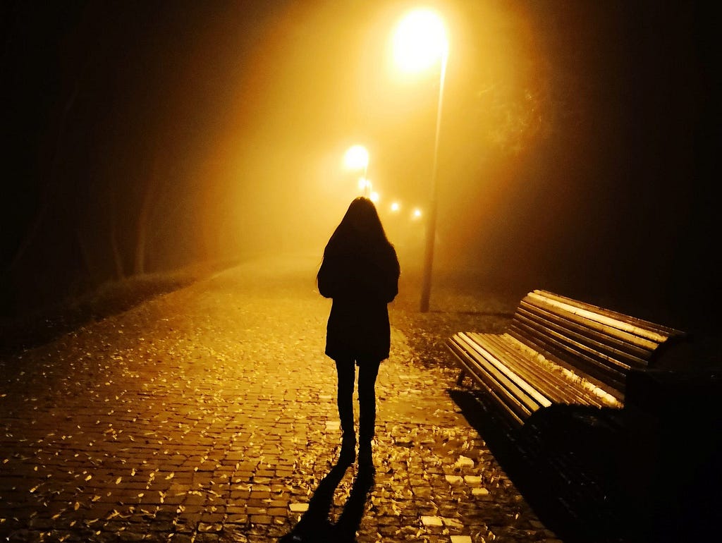 An individual walking at night