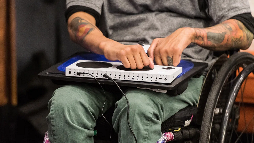 Microsoft’s Xbox Adaptive Controller on lap of person using a wheelchair.