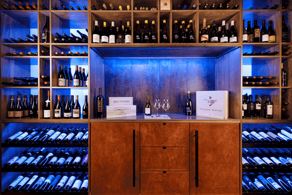 Multi-colored LED backlighting gives a stunning, modern look to this wine cellar design by Sommi Wine Cellars.