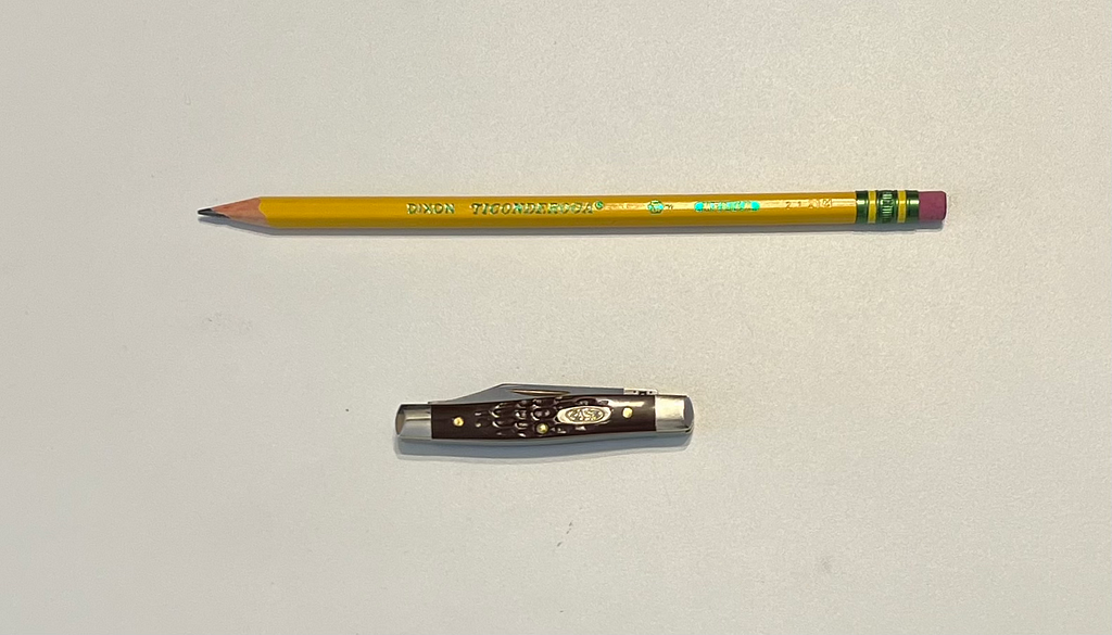 A number two yellow pencil and an antique pocket knife