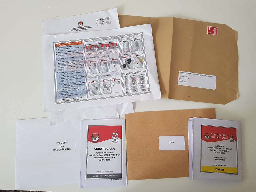 Postal voting package sent to an Indonesian voter in the United Kingdom for the 2019 general election. The grey-marked ballot is for the presidential election, while the yellow-marked ballot is for the legislative election for the Jakarta 2nd constituency (Central Jakarta, South Jakarta and abroad voters).