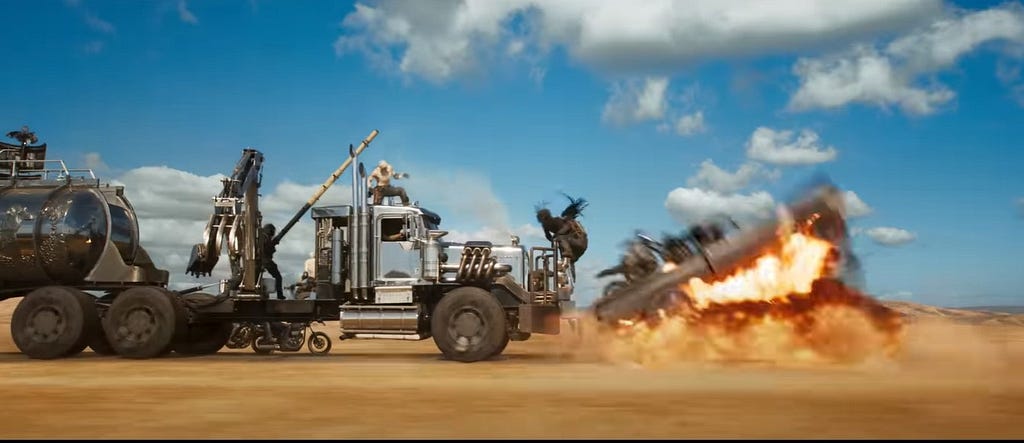 A screencap from an action sequence from the film showing a Warmachine destroying another vehicle in front of it.
