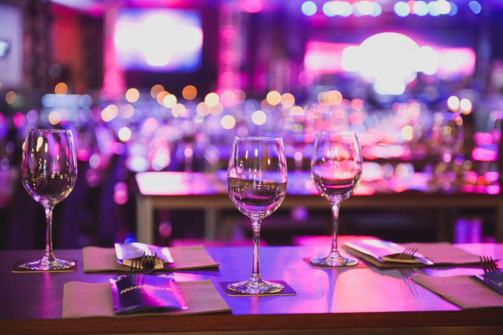 three clear wine glasses on the desk Photo by Jacek Dylag on Unsplash