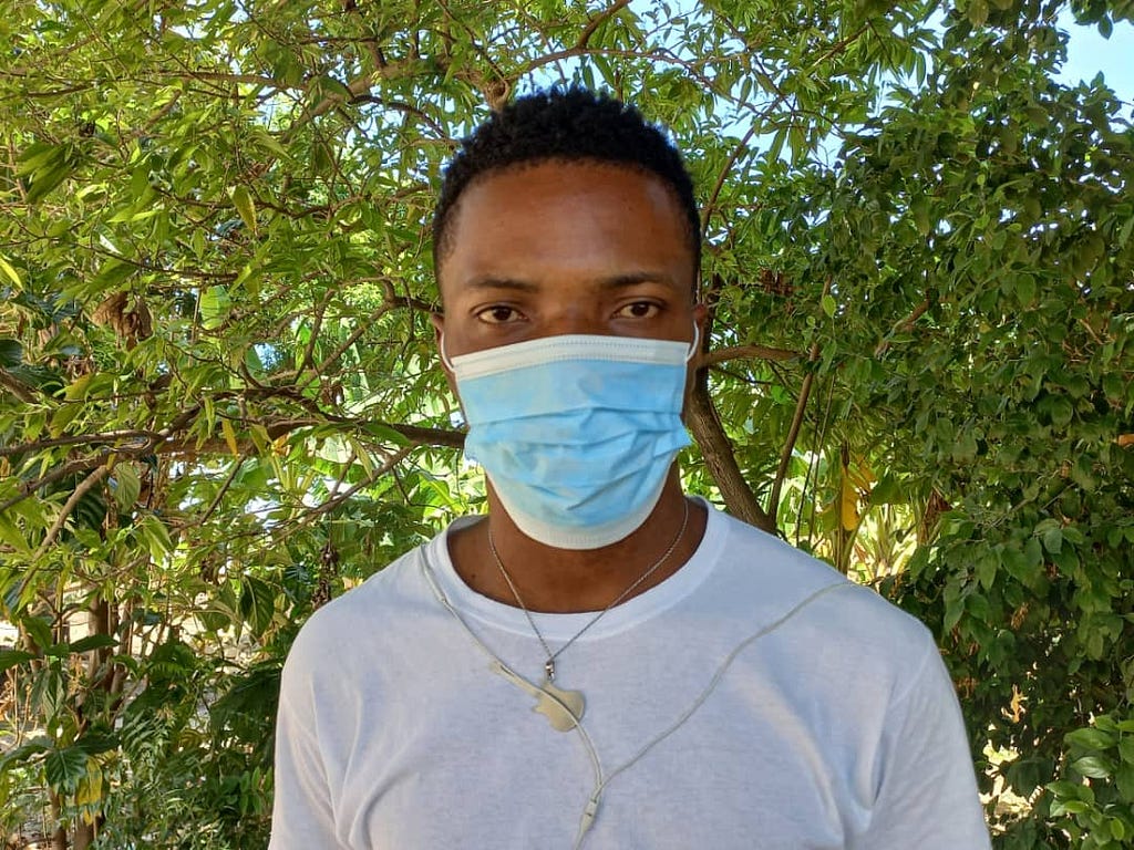 Duclervil Davidson poses for a photograph after receiving a dose of LF medication for the first time during an annual distribution campaign in 2022. Photo credit: RTI International/ Jonathan Sylveste