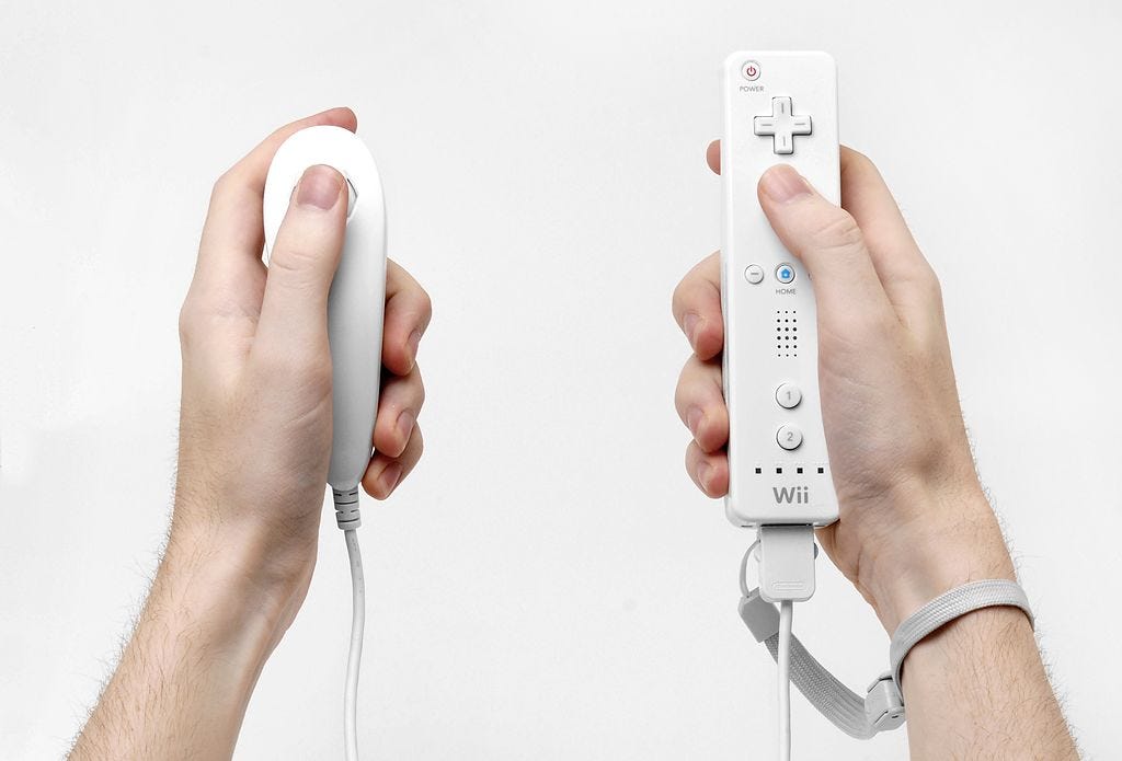 Picture of two hands holding a Wii remote and a Wii nunchuk