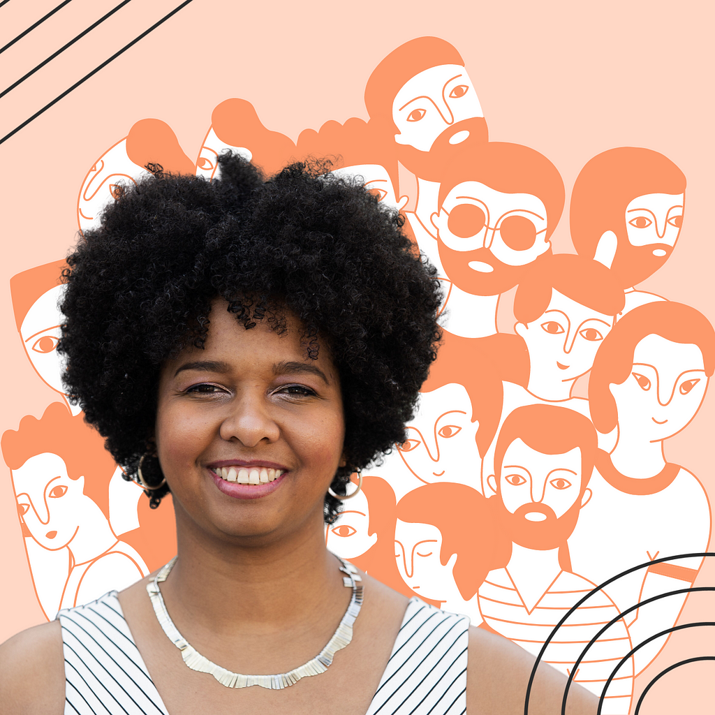 A picture of Amber Thompson in front of a peach-colored mural of people’s faces.