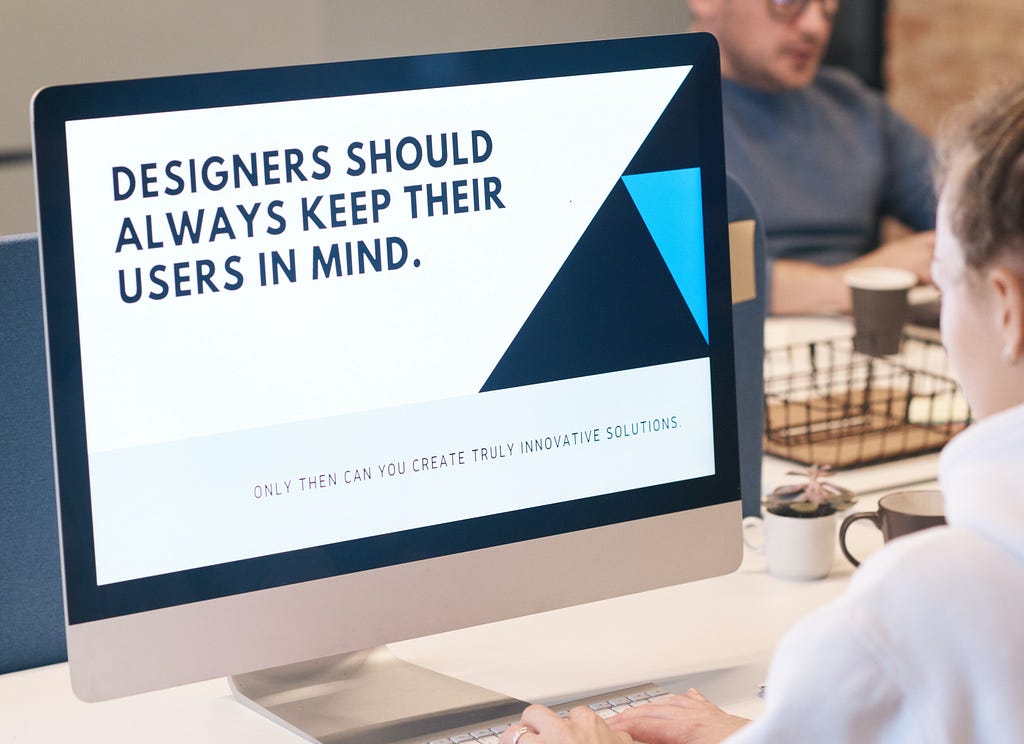 A desktop screen with a simple white and blue design with text that reads “Designers should keep their users in mind”.