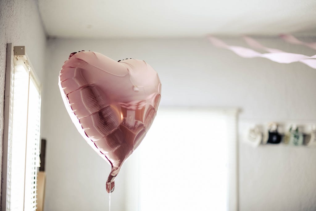 A helium heart-shaped balloon — photo by Samantha Gades on Unsplash