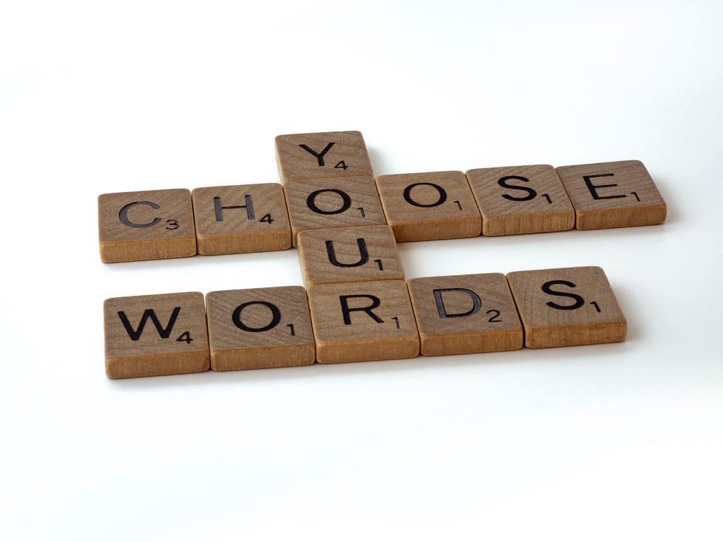Picture which scrabble stones show the words “Choose your words”.