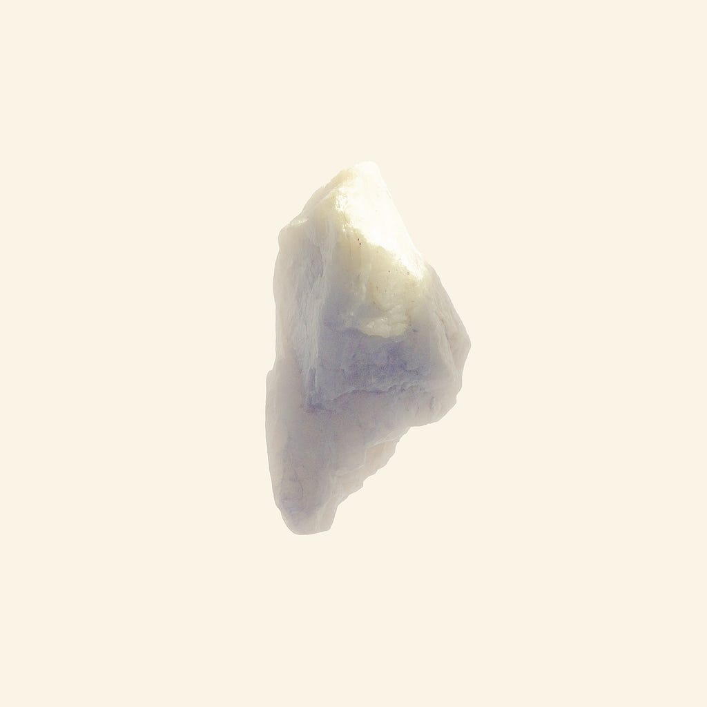 A shiny rock sits in a void.