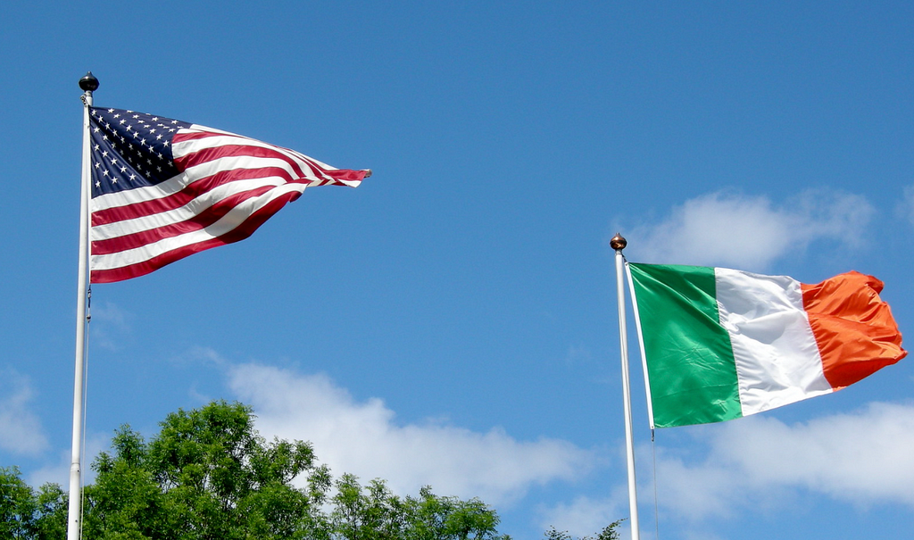 American and Irish flags are seen waving.