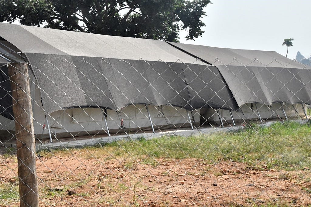 An Ebola treatment unit behind a fence.
