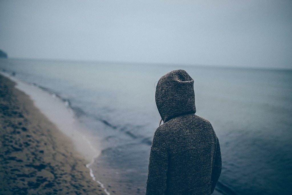 someone standing behind seashore photo