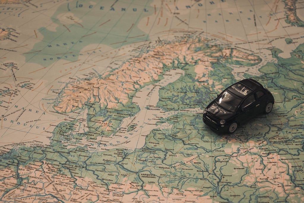 Model toy car placed on top of a map of Europe