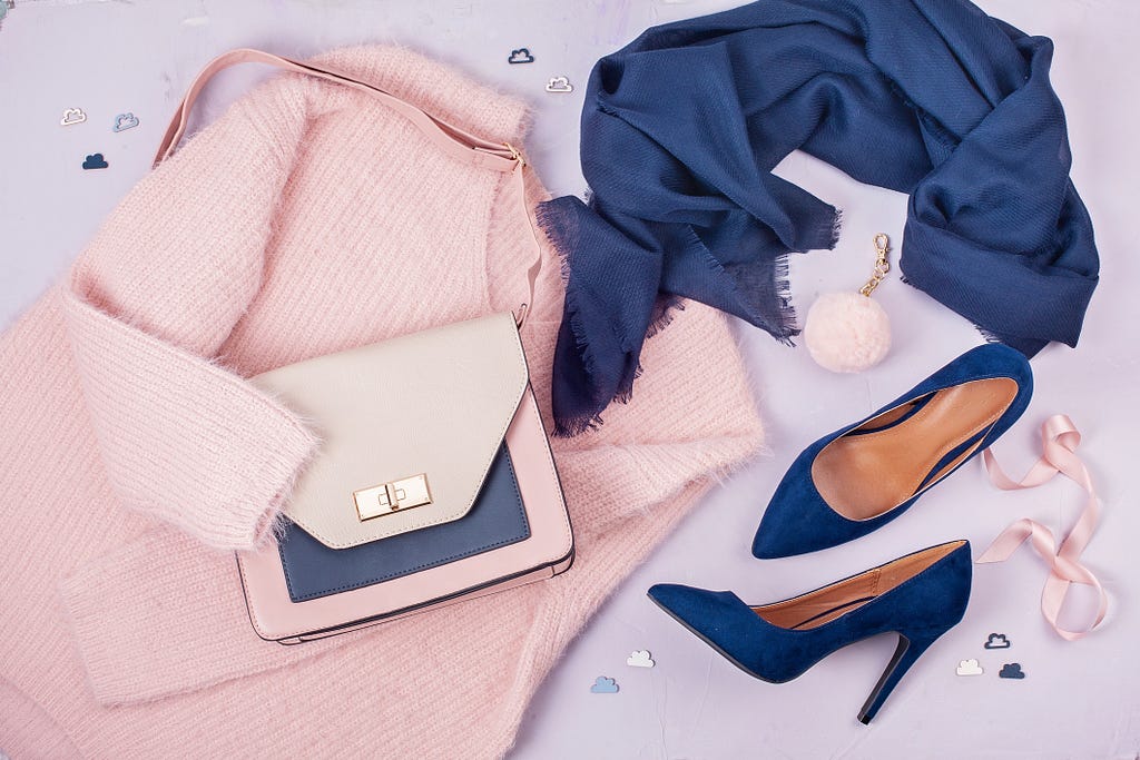 Blue high heels, pink jacket, and pink purse, viewed from above