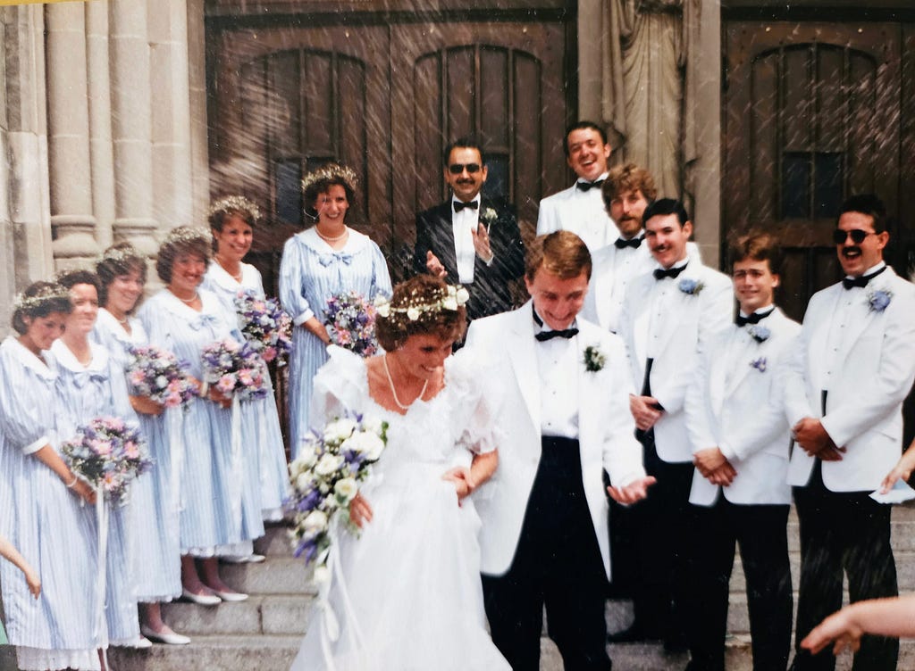 Our wedding day in 1986 with wedding party on the steps of the church