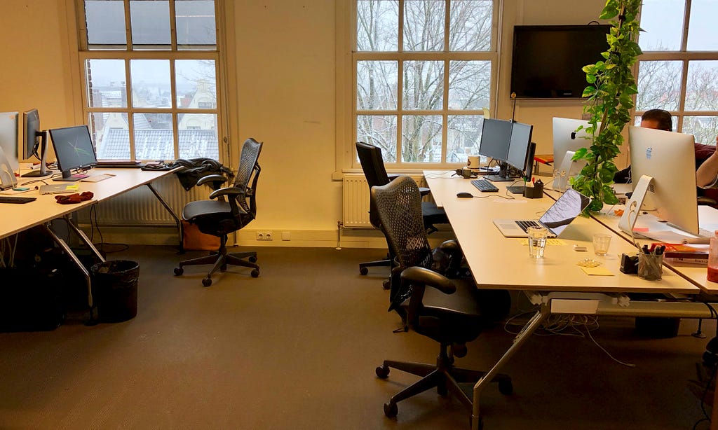 Four empty desks in an office building during winter
