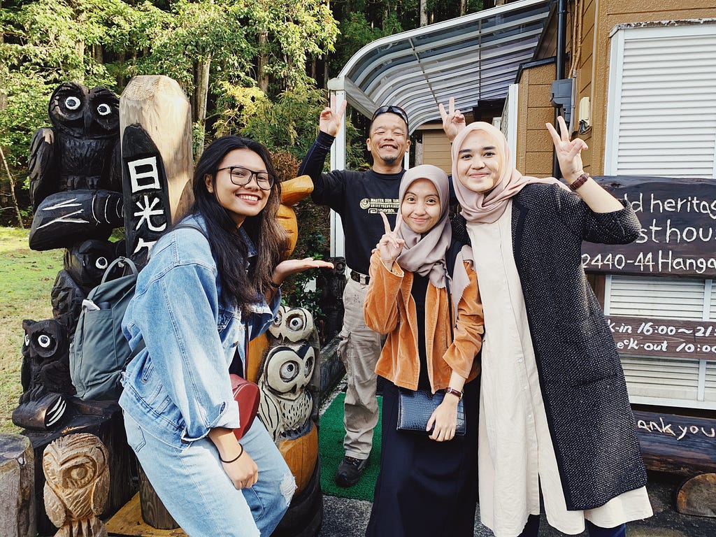 Four people standing in front of the guesthouse in Nikko, Japan.