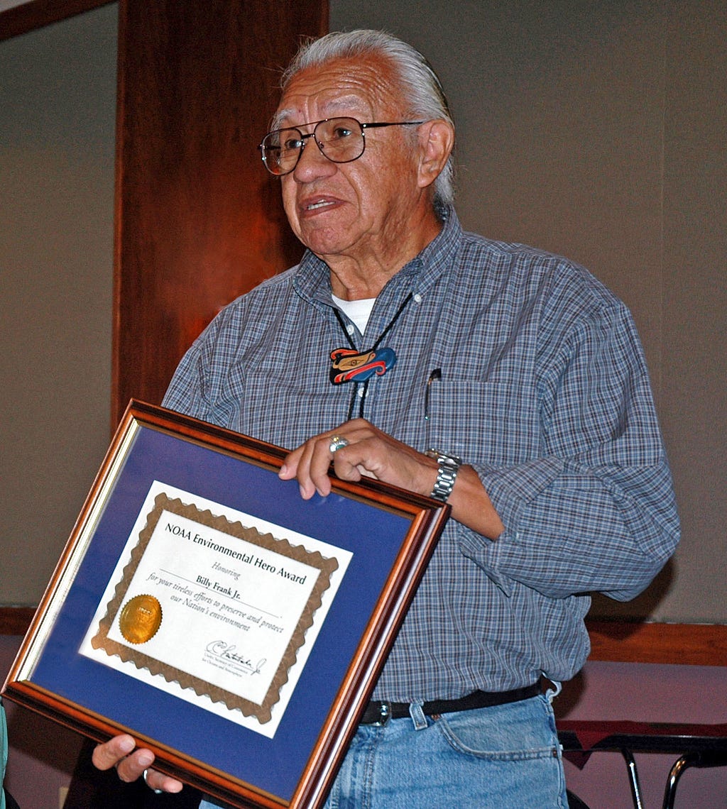 Photo of Billy Frank Jr. holding an award certificate from NOAA. Photo credit: Northwest Indian Fisheries Commission.