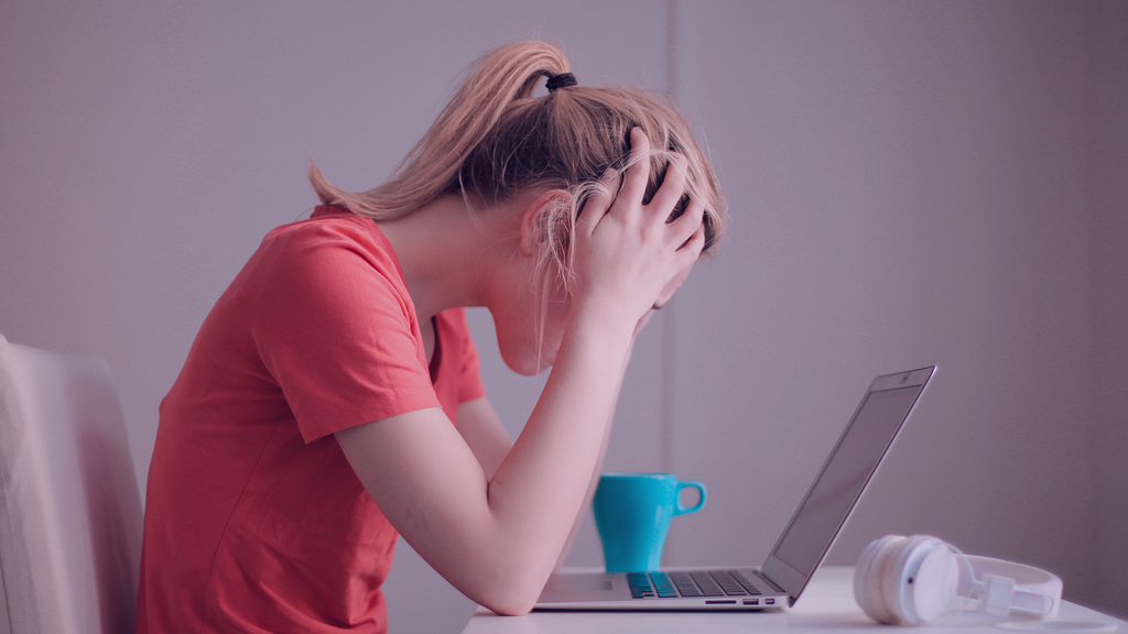 A woman holding her head in frustration.