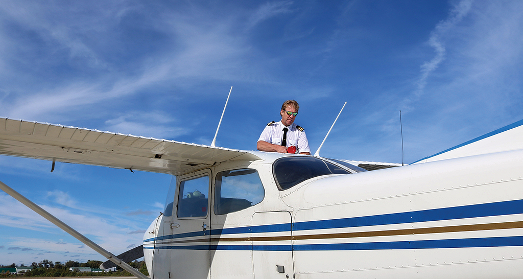 Photo of pilot refueling airplane.