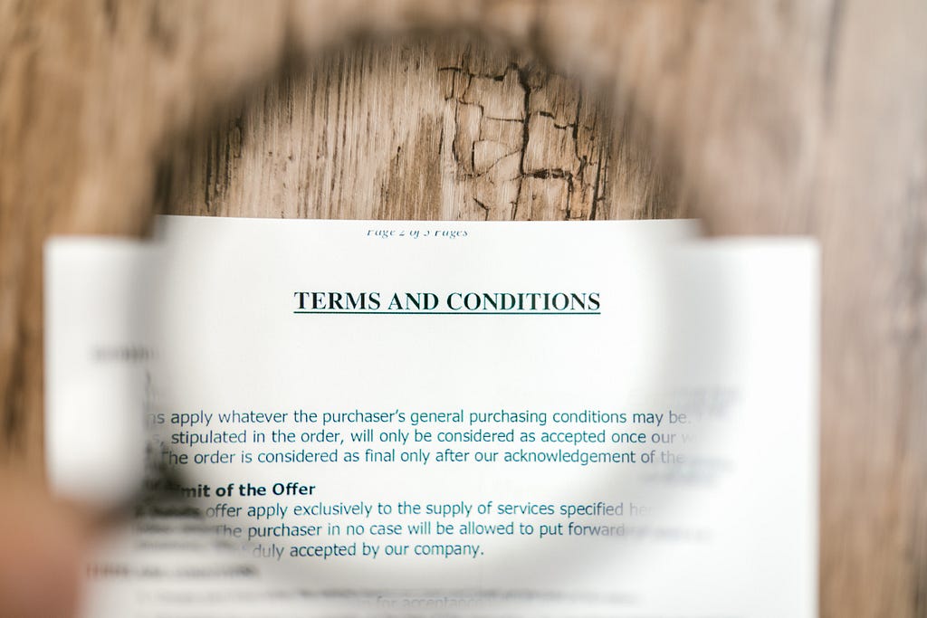 Selective focus photo of terms and conditions written on a paper.