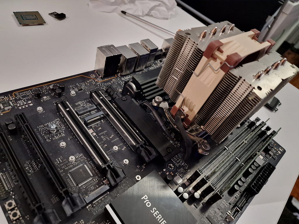 A picture of a motherboard with a small tower cooler.