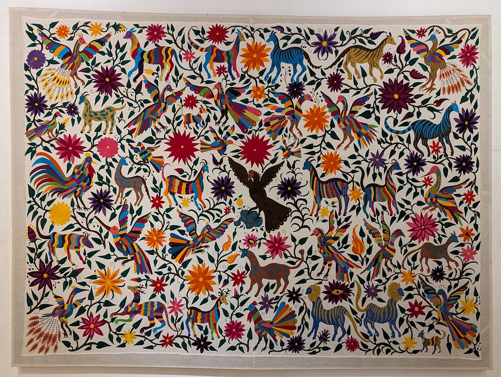Colourful embroidery by María de los Ángeles Licona San Juan. Displayed at Museo Indígena (Indigenous Museum), Mexico City. Part of the Colección Instituto Nacional de los Pueblos Indígenas (National Institute of Indigenous Peoples Collection).