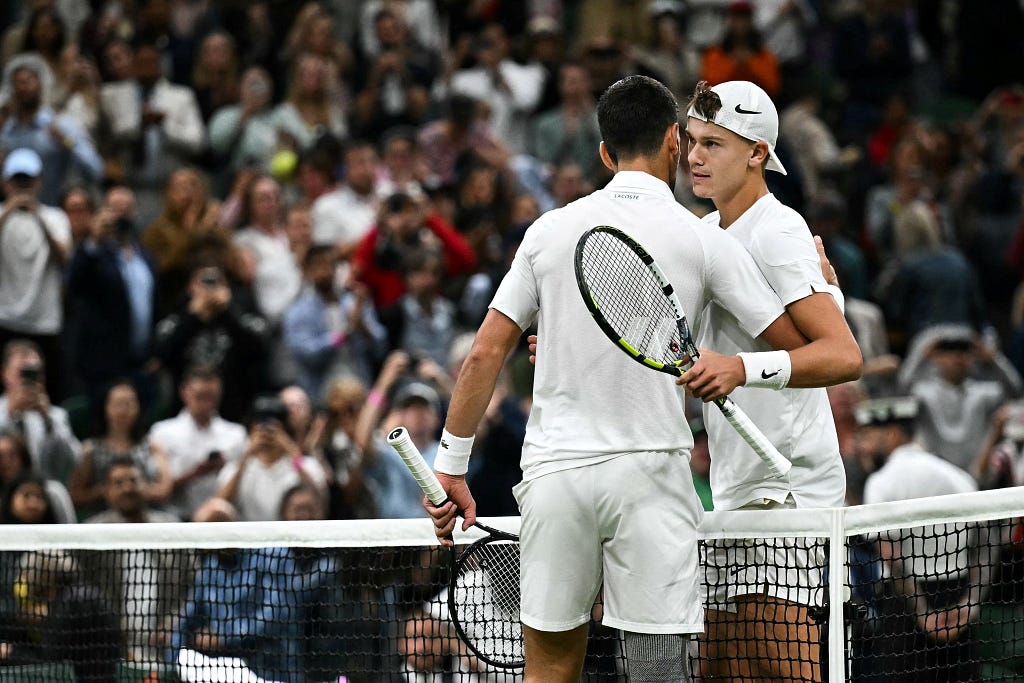 A terrible first set from Rune on display at Center Court. The two hug at center court at Wimbledon after the match. | Image Credit: Ini-Iso Adiankpo/Medium