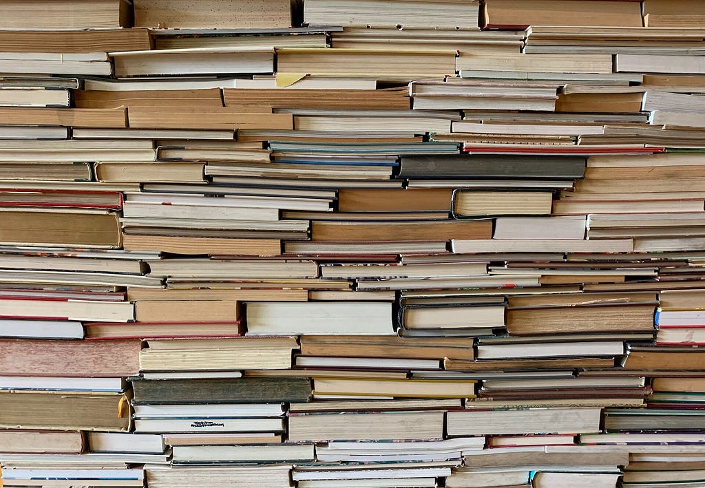 A wall of books piled on top of each other