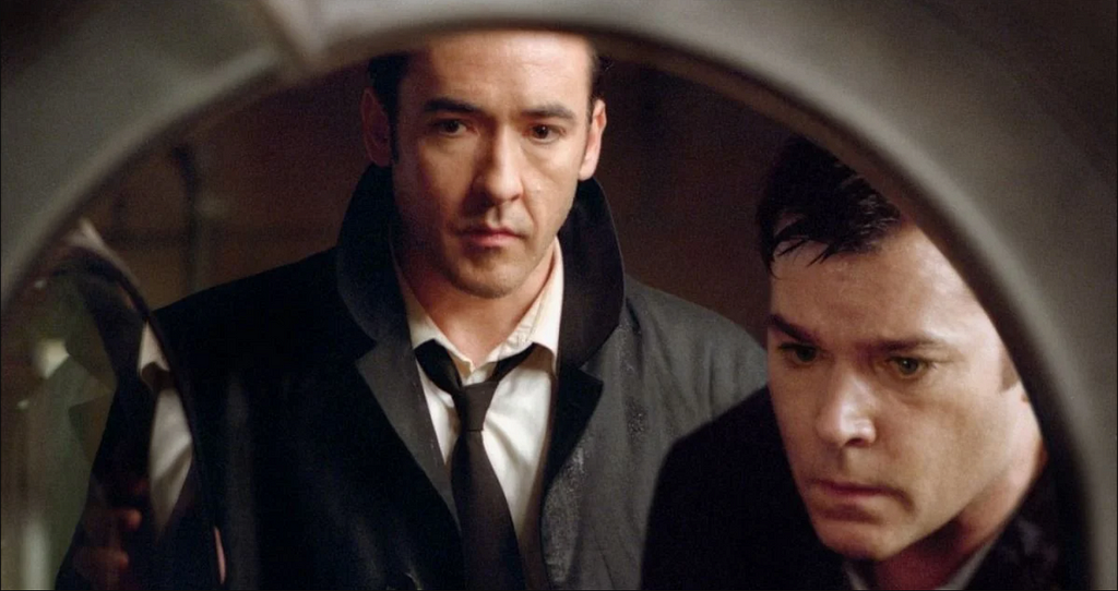 John Cusack and Ray Liotta gaze into an open drier in “Identity.”