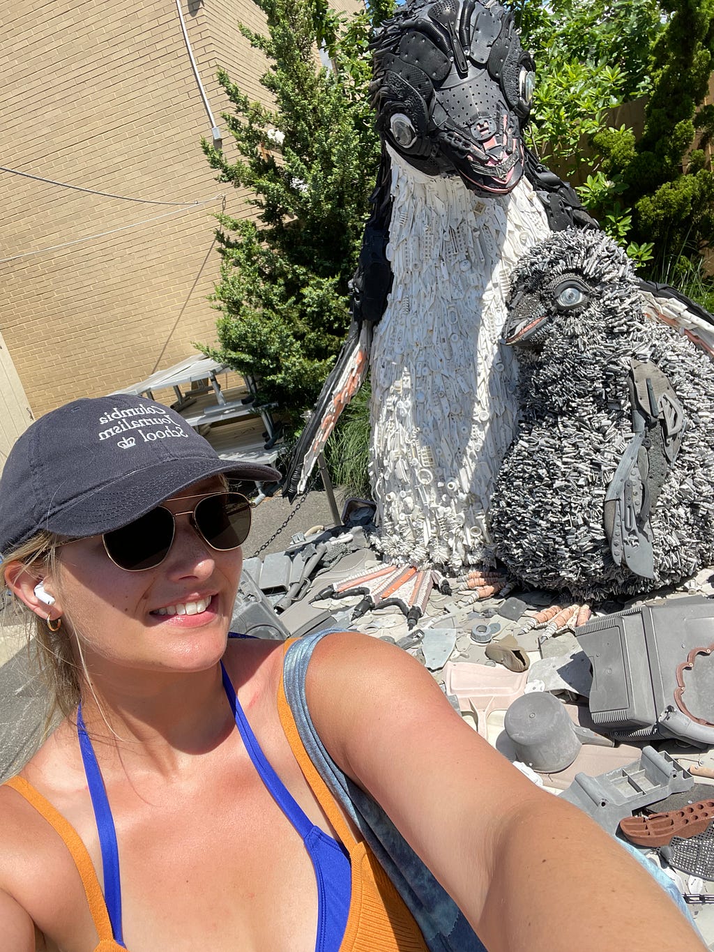 I pose with Adélie penguins made of repurposed ocean plastic at the New York Aquarium