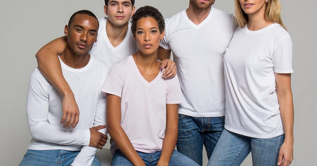 A group of women and men wearing white sustainable t-shirts from The Classic T-shirt Company.