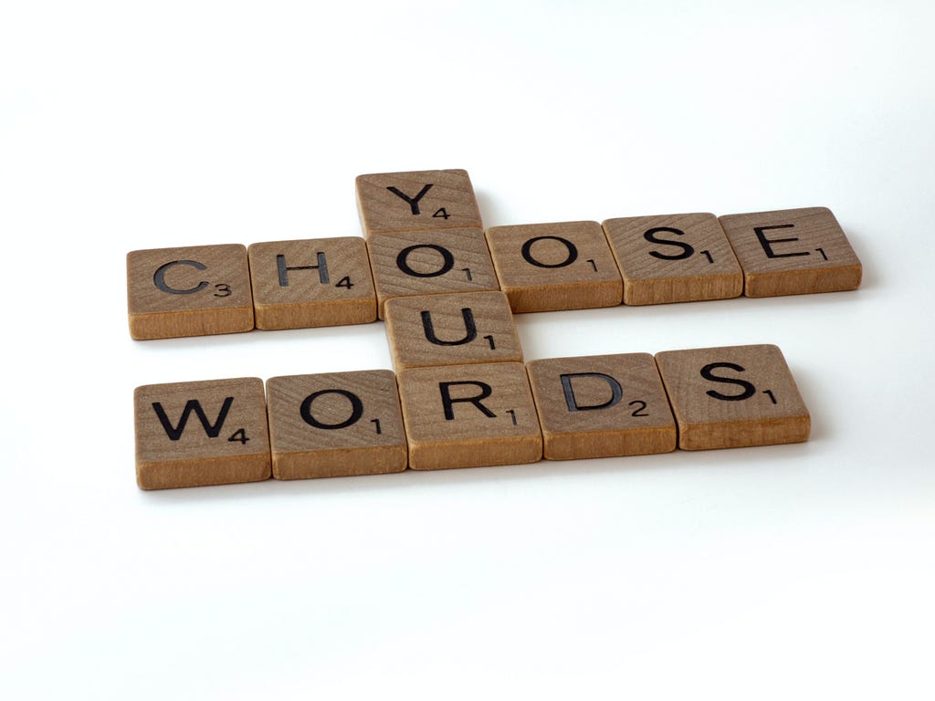 Scrabble game pieces that say “Choose your words”