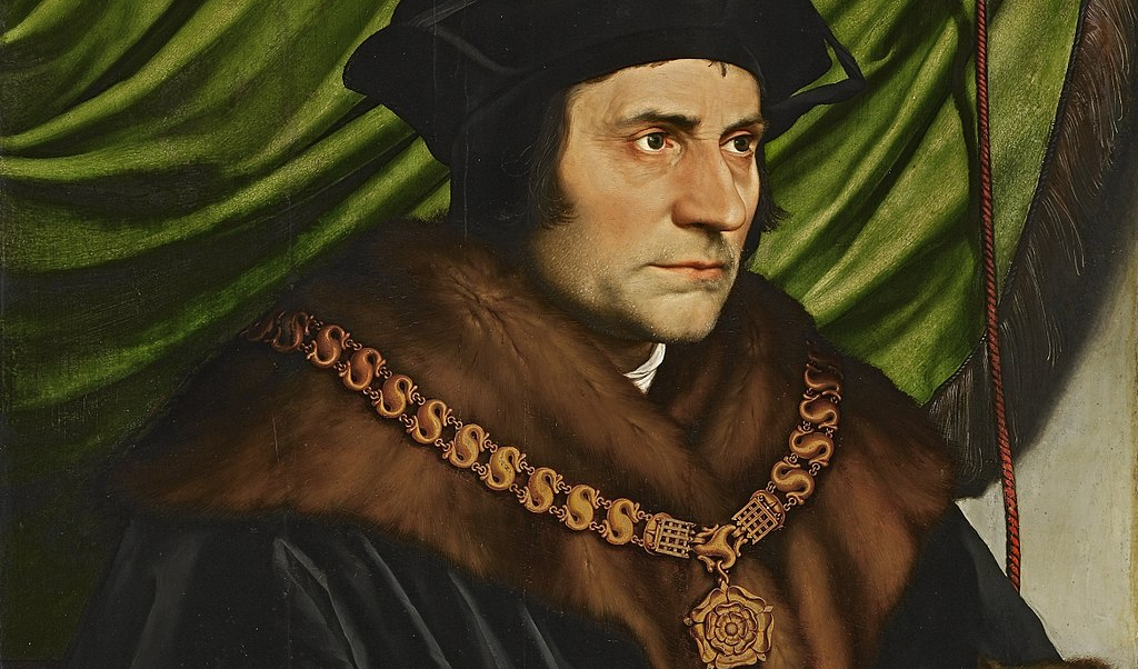 A painting of a 16th century man with light skin and dark hair wearing a brown fur cloak and a heavy gold chain, sitting in front of a green curtain.