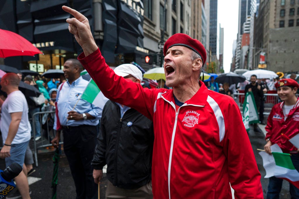 Curtis Sliwa founder of the Guardian Angels, yells toward New York Mayor Bill de Blasio during the annual Columbus Day Parade in New York, Monday, Oct. 9, 2017. (AP Photo/Craig Ruttle)