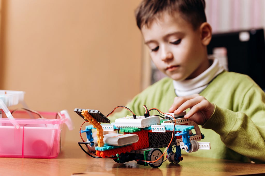 A child building a Lego robot.